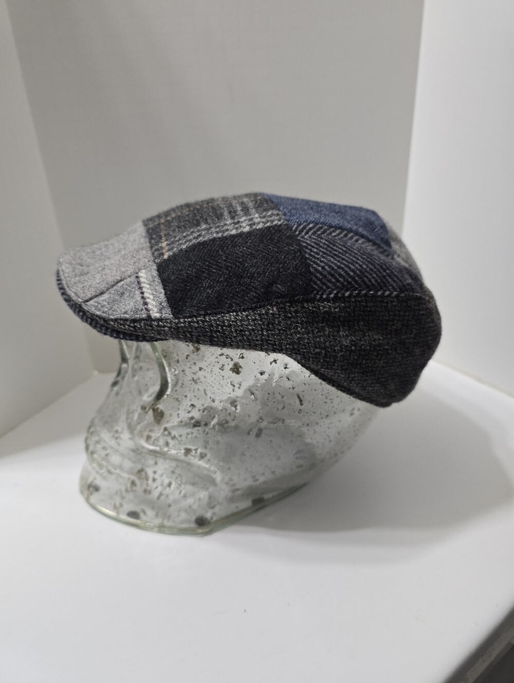 Hanna Hats patchwork touring cap features a blue and grey   Burgundy Lining